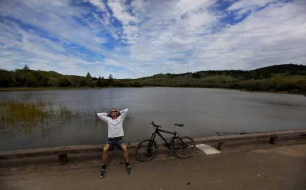 Jim McGary of Santa Rosa stretches in the sun on the Lake Ilsanjo dam, while on his lunch break. (Kent Porter/ The Press Democrat, 2011)